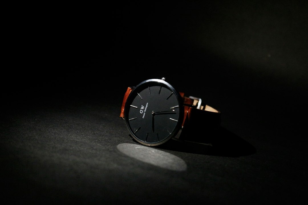 Elegant gold luxury wristwatch resting on dark leather