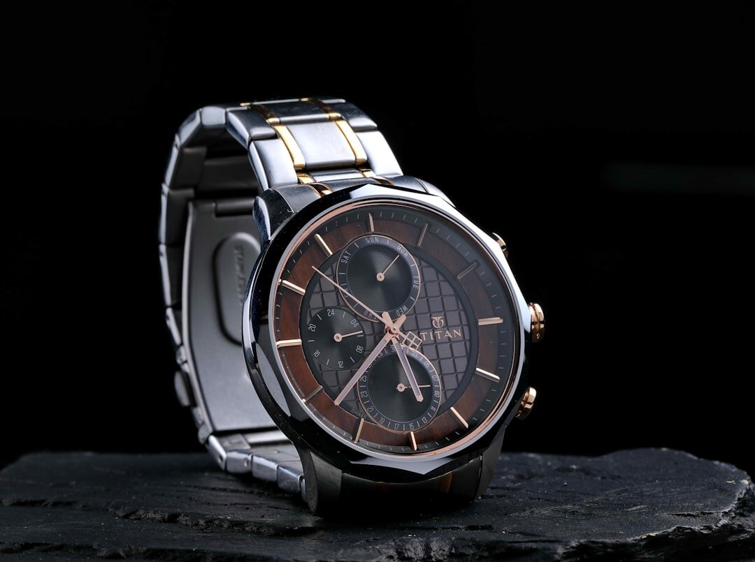 Slim silver dress watch with leather strap on marble